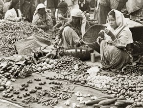 Fruit and vegetable stall at Darjeeling market. Two women sell various fruits, vegetables and