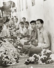Workers in a goggle factory, Calcutta. Indian factory workers inspect and box up hundreds of pairs