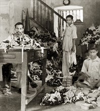 Workers in a goggle factory, Calcutta. Indian factory workers inspect and box up hundreds of pairs