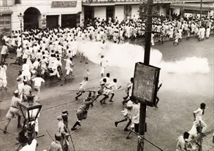 Police disperse riots in Calcutta, 1946. Indian police use lathis (bamboo sticks) and tear gas to