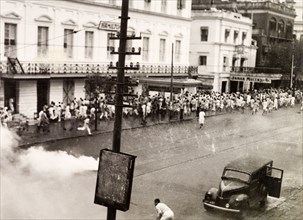 Tear gas disperses riots in Calcutta, 1946. Indian police use tear gas to disperse rioting crowds