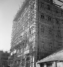 Bamboo scaffolding, Calcutta. A tall building is encased in bamboo scaffolding as it undergoes