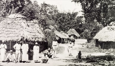 Rural Jamaican village. View of a rural Jamaican village, where residents stand outside a cluster