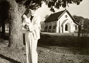 Methodist missionary cradling his daughter. Methodist missionary Reverend Norman Sargant cradles