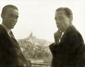 Visiting Marseille. Two British men pose whilst looking over the city of Marseille, where the