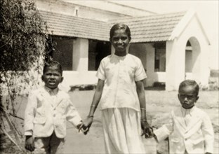 Indian siblings in Western-style dress. Portrait of three Indian siblings in Western-style dress
