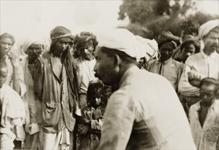 Evangelist preaching to villagers. Methodist evangelist T.B. William preaches to a crowd of Indian