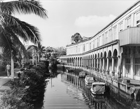 A waterway in Suva. An arcade borders a waterway in central Suva, where several small boats are