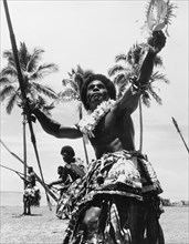Men perform a 'meke wesi'. A group of men perform the 'meke wesi', a male war dance from Fiji that