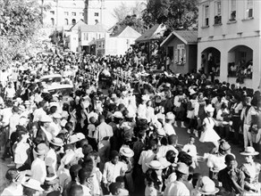 Carnival procession in St John's. Crowds pack the main street in St John's during a carnival