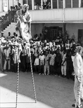 A Moko-Jumbie in Antigua. A Moko-Jumbie (stiltwalker) entertains a sullen crowd during carnival