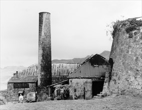 A sugar mill in Monserrat. A brick chimney and outbuildings form part of a sugar mill that was once
