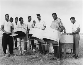 A steel band in Basseterre. A group of young men play converted petrol drums in a steel band.
