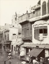 Street scene in Lahore. View of a shop-lined street in Lahore, taken from the back of an elephant.