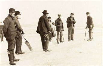 Ice cutters on Lake Ontario. A team of ice cutters, ice saws in hand, prepare to remove ice from