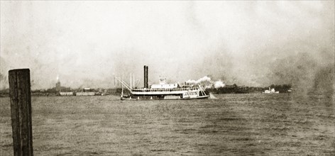 Grain boat, Mississippi'. A steamship carrying a shipment of grain travels along the Mississippi