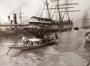 Calcutta docks, 1902. A variety of vessels including steamships, sail boats and canoes travel along