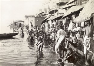 A bathing ghat, Benares. Hindu pilgrims bathe at a ghat (stepped wharf) on the River Ganges at