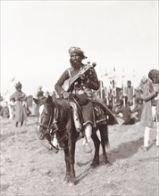 Musician at Coronation Durbar, 1903. A mounted chief from Haripur State plays a traditional Indian