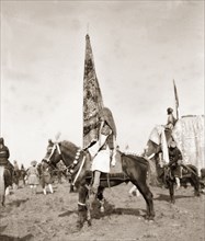 Flag bearer at Coronation Durbar, 1903. A mounted standard-bearer holds up an Indian princely state
