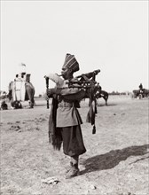 Sikh bearer playing bag pipes. A Sikh bearer plays a bag pipe during celebrations at the Coronation