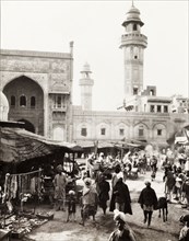 Marketplace in Lahore. View across a bustling marketplace to the minarets of the Sunehri Masjid