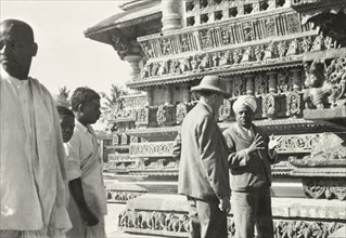 Sculptures on facade of Chennakesava Temple,. Two men, Mr F.C. Scott and Mr Sitaramayya, discuss
