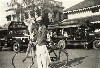 Outside Chikmagalur Post Office. Methodist evangelist Mr S. James poses with his bicycle on the