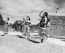 Maori women perform the 'double long poi'. A group of Maori women perform the 'double long poi', a