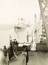 Italian supply ships on the Suez Canal, 1936. Passengers on the deck of S.S. Ranchi look overboard