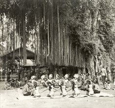 A traditional Balinese dance. Young Balinese men and women sit in a circle as they perform a