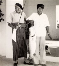 Prize fish from West Bengal. Frank Snaith poses proudly for the camera, dressed in a traditional