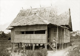 New house, North Borneo. A stilted, bamboo house with a thatched roof, an example of the new