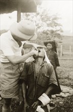 Dental treatment at Keningau Health Centre. A man receives dental treatment from a British medical