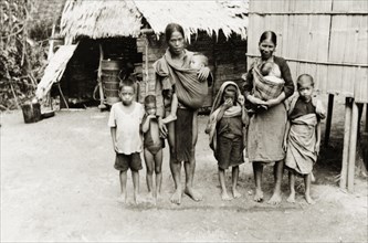 A large Malay family, North Borneo. Group portrait of a Malay family, two parents and six young