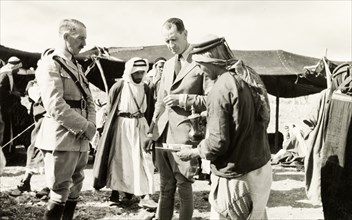 Coffee break at a council in the desert. William Ryder McGeagh (centre), District Commissioner in