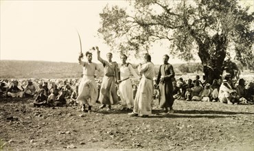 Dabke' dance at a Palestinian wedding. A group of men dressed in 'thobs' (ankle-length garments