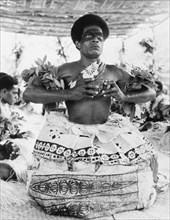 Preparing to drink a kava infusion. A Fijian man prepares to drink an infusion of water and