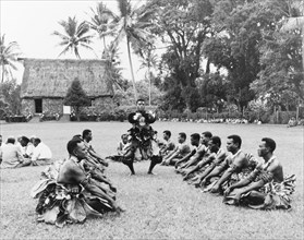 Preparations for a 'sevusevu' ceremony. A group of Fijian men perform an elaborate dance before a