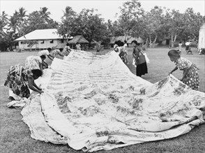 Laying out a 'masi' cloth. A group of Fijian women lay out a finished 'masi' or 'tapa' cloth, made