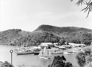 View over English Harbour. Various types of sail boat are moored at English Harbour, the site of an
