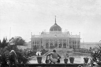 The Chhota Imambara in Lucknow. A figure crouches in front of an ornamental pool at the Chhota