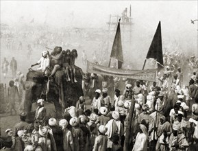 Procession at the Ardh Kumbh Mela. A procession containing elephants and banners passes through
