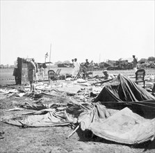 Storm damage at an Indian Police camp. Officers sift through debris at the camp of James Ferguson,