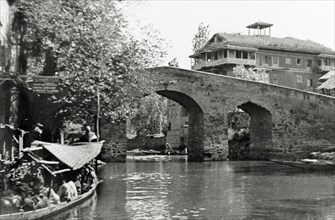Canal bridge in Srinagar. A hump-backed stone bridge spans a Srinagar canal. Srinagar, Jammu and