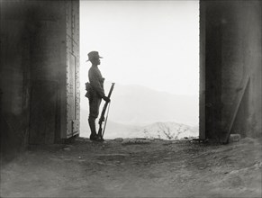 Guarding the entrance to 'Fort Malakand'. An armed officer of the Eighth Royal Gurkha Rifles stands