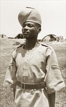 Portrait of an Arab 'onbashi'. An Arab 'onbashi' (corporal) stands to attention, wearing military