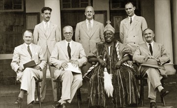 Western officials with a Nigerian chief. Western officials pose for a group portrait with a