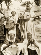 Nigerian musicians with their instruments. Four Nigerian musicians pose for a group portrait with