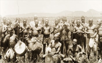Labourers and musicians, Nigeria. A group of labourers assemble for a group portrait around four